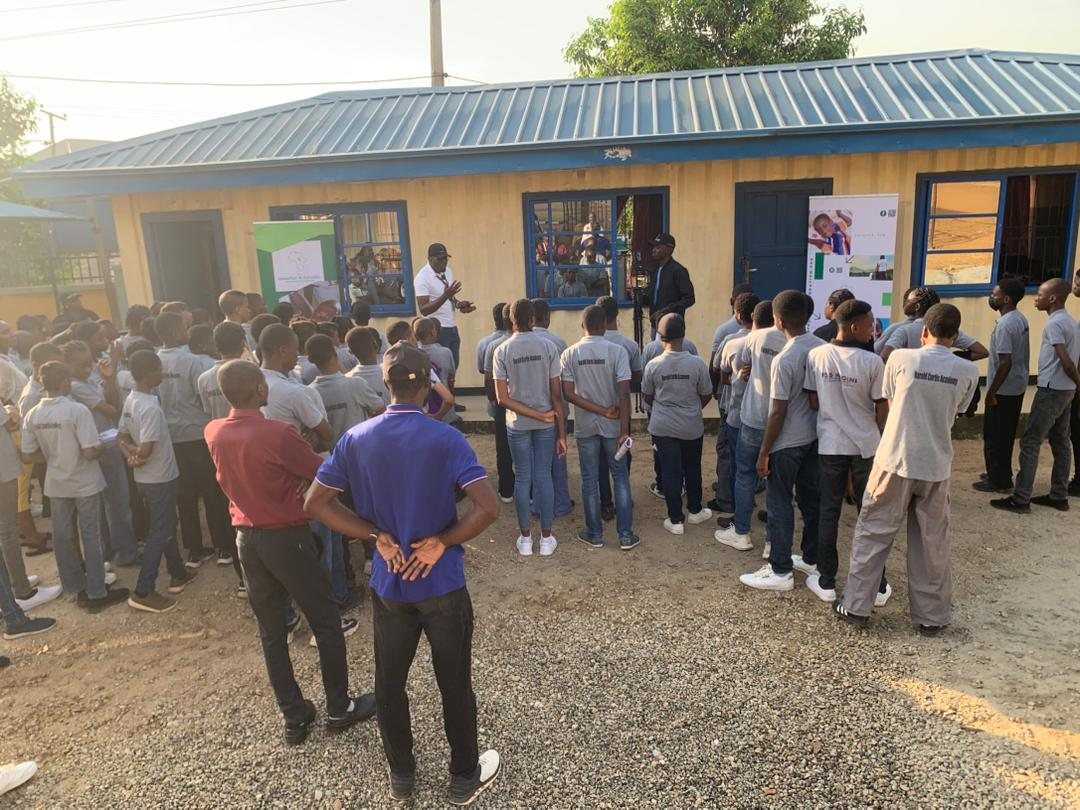 Students gather around the notice board.