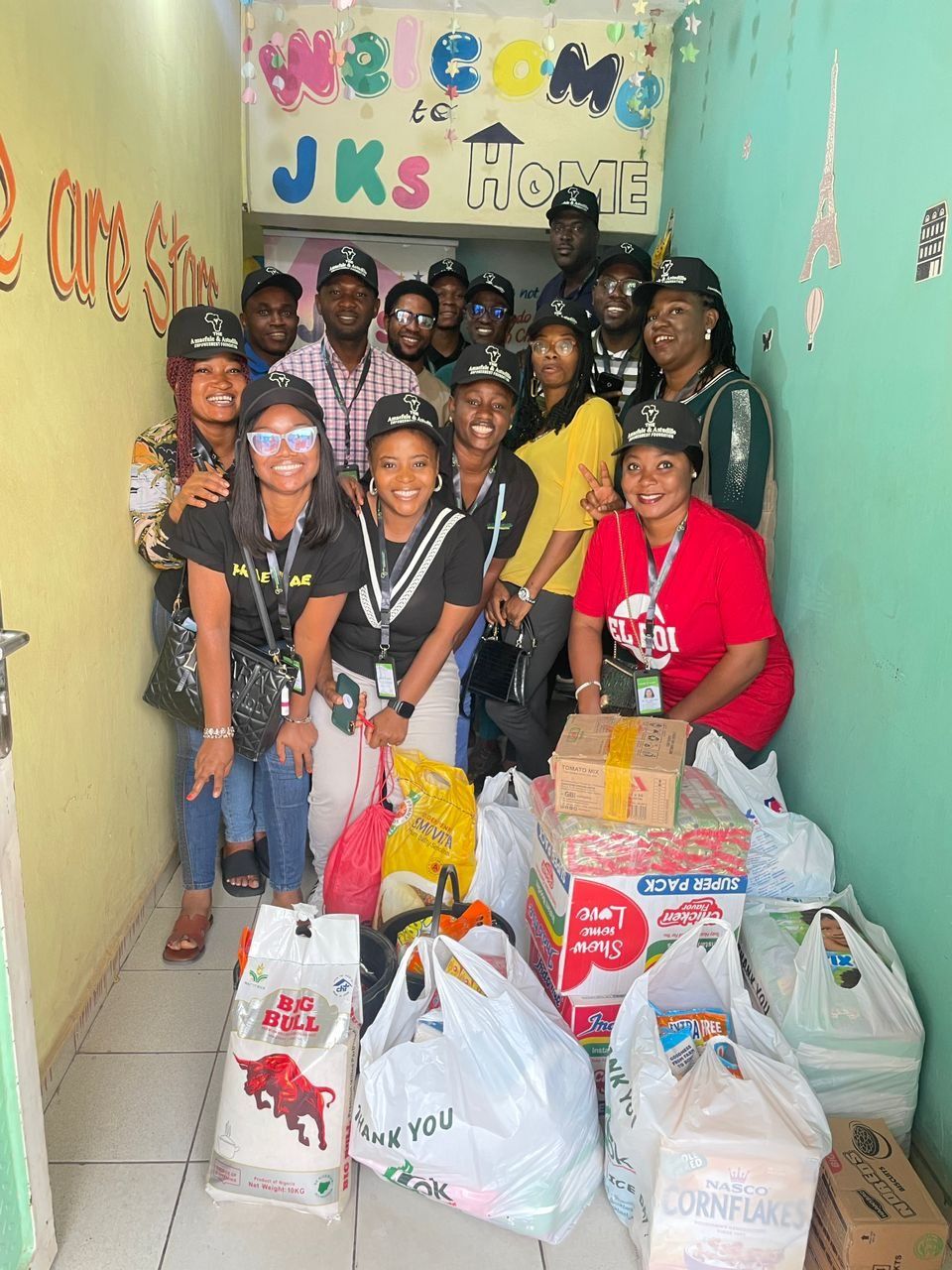 The team with donations under the JKS welcome sign.
