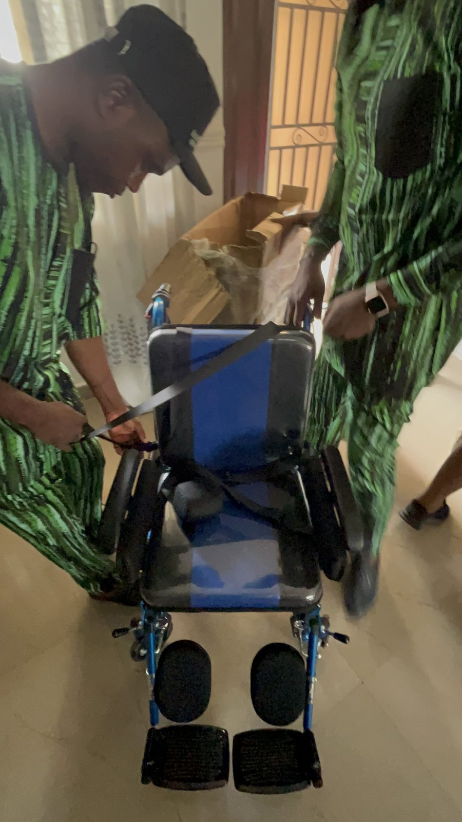 Petra's new wheelchair being adjusted by the team.