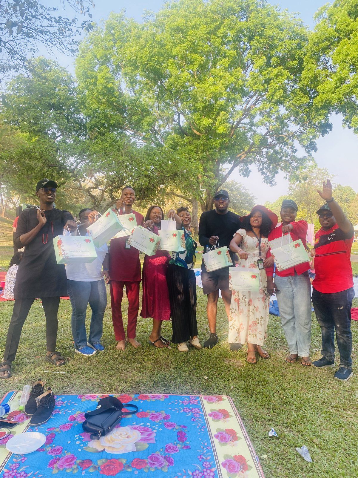 Volunteers together under the trees.